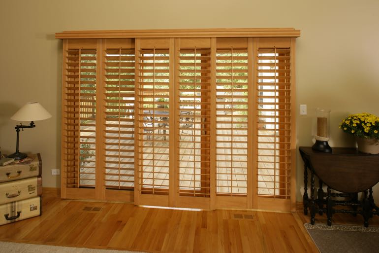 Faux wood shutters on sliding door going to back porch.